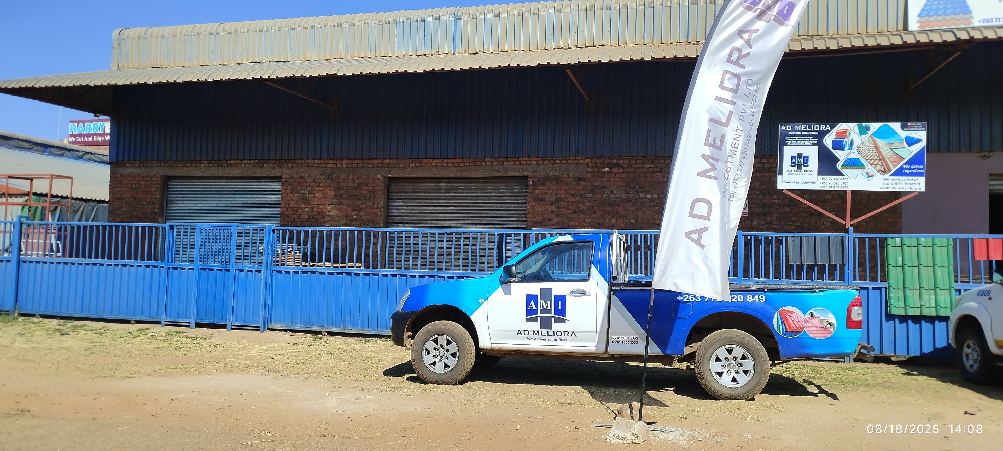 AD Meliora branded pickup outside the premises, stocked for building-materials delivery