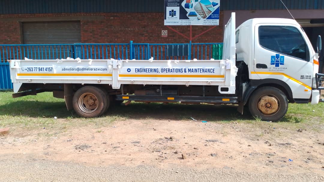 AD Meliora branded flatbed delivery truck