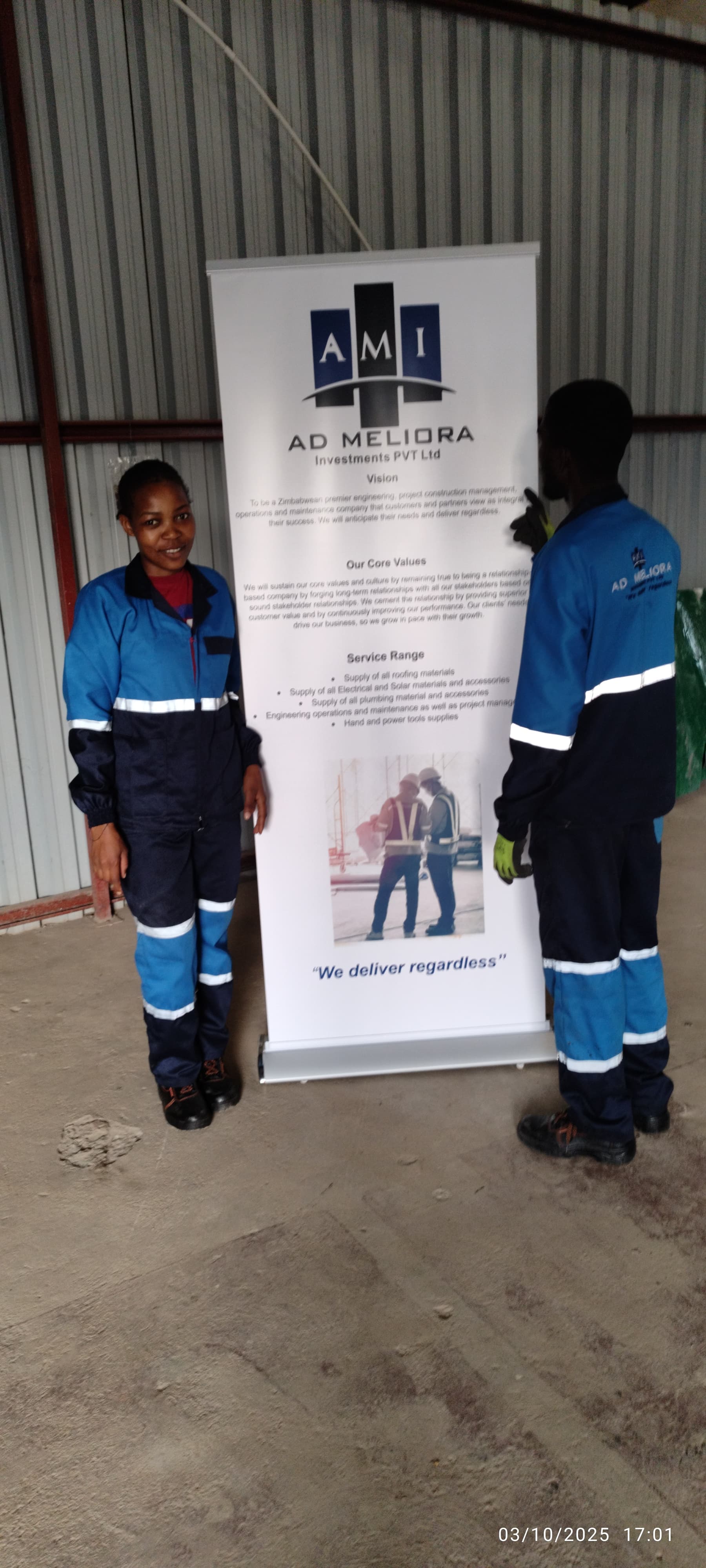 AD Meliora technicians in PPE beside the company vision and values banner