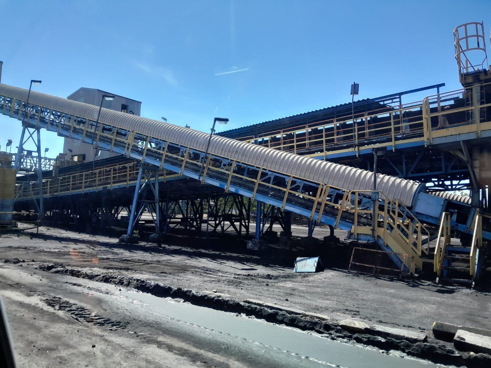 Elevated conveyor bridges at an AD Meliora mineral-processing site