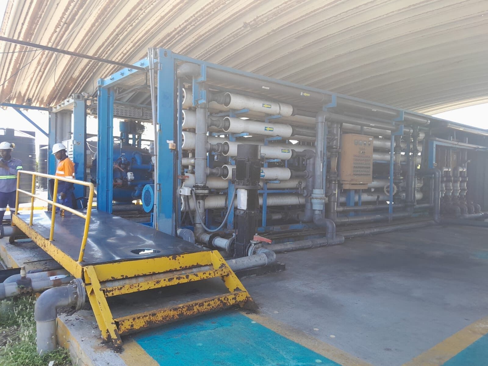 AD Meliora technicians beside a containerised RO water treatment skid